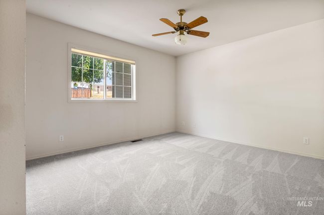 Carpeted spare room with ceiling fan and baseboards | Image 16