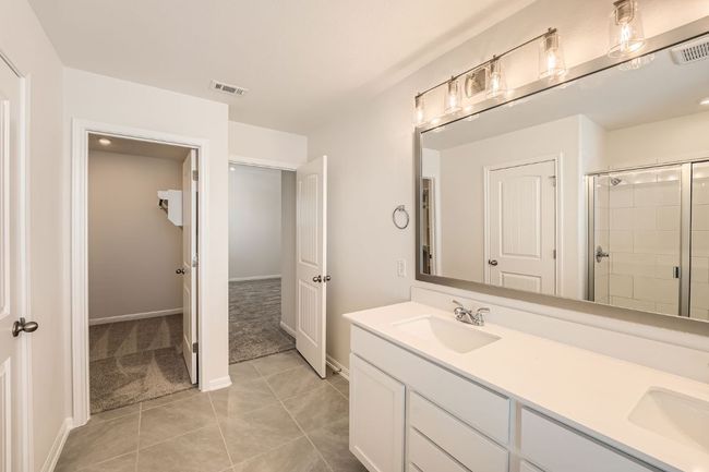 Full bathroom featuring a stall shower, visible vents, and a sink | Image 17