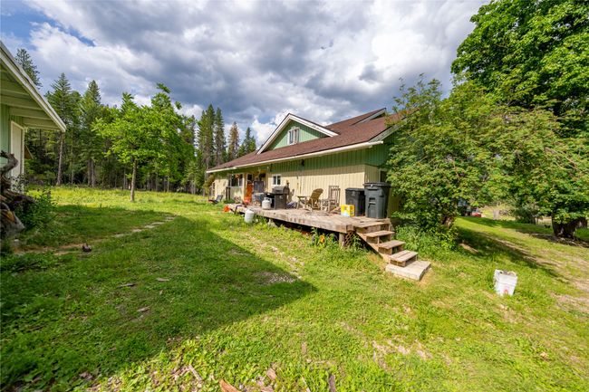 View of green lawn featuring a deck | Image 51
