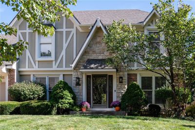 English style home featuring a front lawn | Image 1