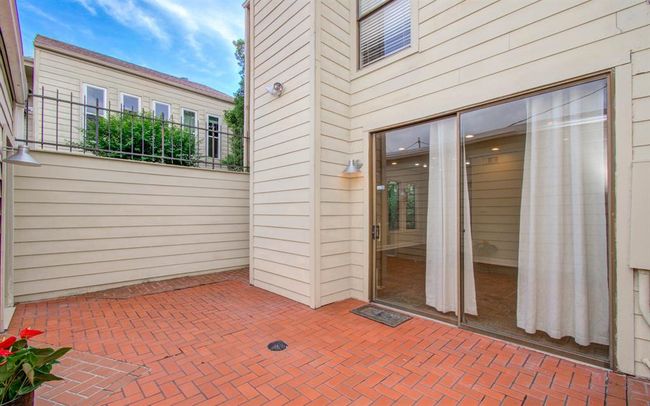 Private and cozy backyard with a spacious brick patio, perfect for relaxing or entertaining. | Image 20