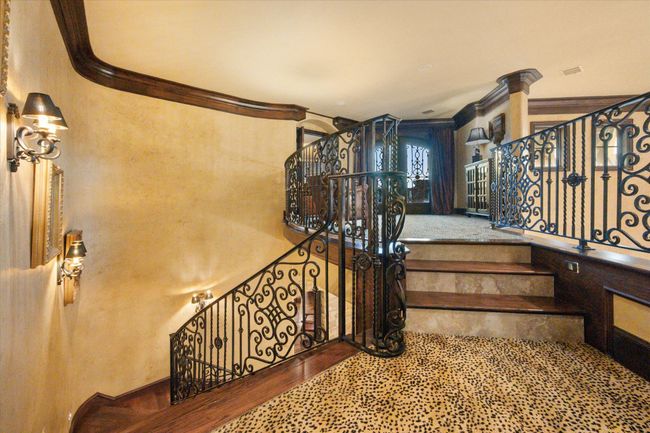 Stairway with ornamental iron leading to upstairs living area and bedrooms | Image 27