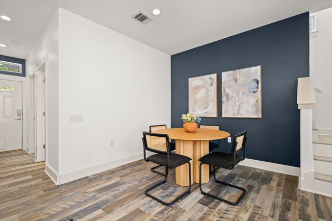 Dining space with wood finished floors, recessed lighting, stairs, and baseboards | Image 9