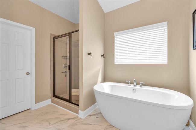 Spa-like en-suite features large soaker tub and walk in shower. | Image 19