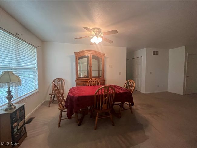 The Kitchen leads right to the Dining Room with a ceiling fan light. | Image 7