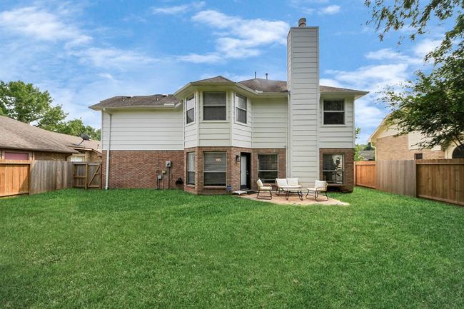 Check out the spacious backyard — complete with a fence, gated access, and plenty of room to enjoy, play, or entertain. A perfect outdoor retreat! | Image 42