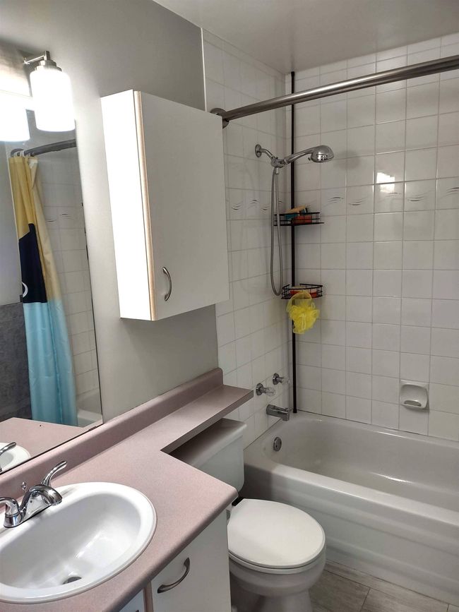 Bathroom featuring toilet, shower / bathtub combination with curtain, and vanity | Image 20