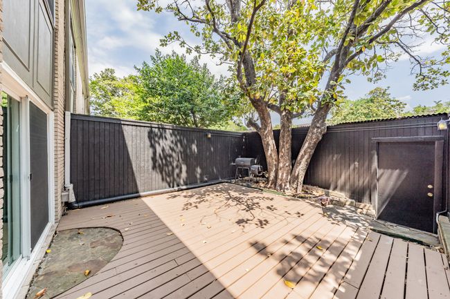 Wooden deck with a fenced backyard | Image 23