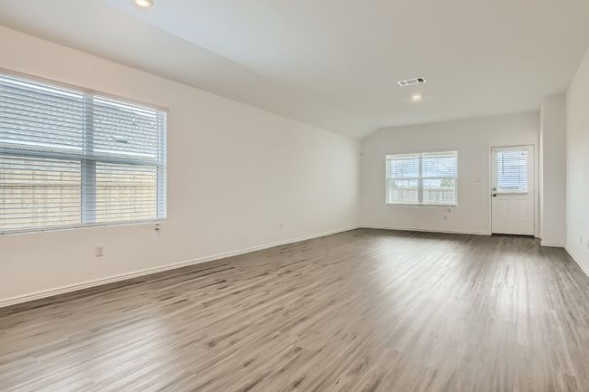 Spare room with wood finished floors, recessed lighting, baseboards, and vaulted ceiling | Image 4