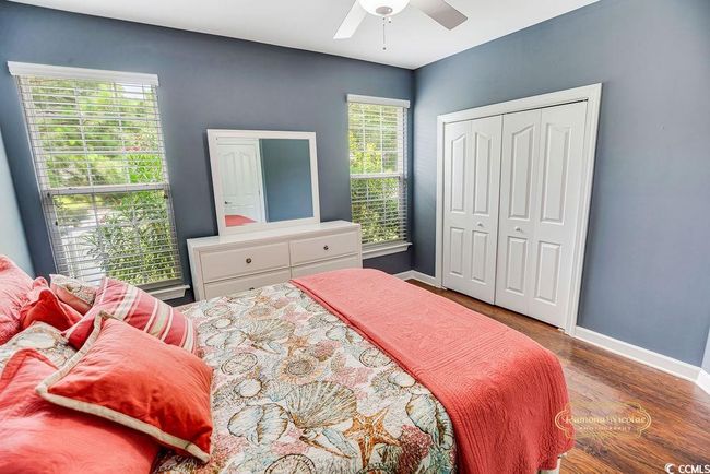 Bedroom with wood finished floors, a closet, and ceiling fan | Image 19