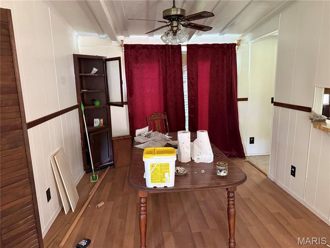 Dining space with wood finished floors, ceiling fan, and beamed ceiling | Image 15