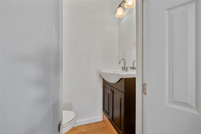 Bathroom featuring vanity, toilet, and wood-type flooring | Image 22