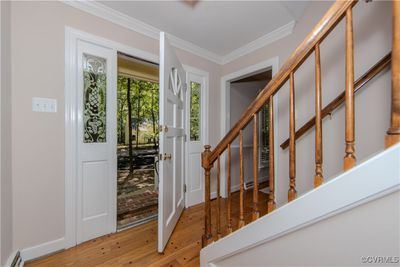 Foyer entrance featuring hardwood / wood-style flooring, baseboard heating, and crown molding | Image 3