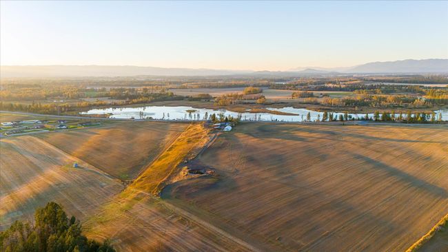 Aerial view at dusk with a rural view and a water and mountain view | Image 67