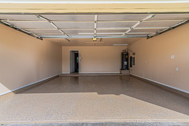 Garage featuring water heater and baseboards | Image 27
