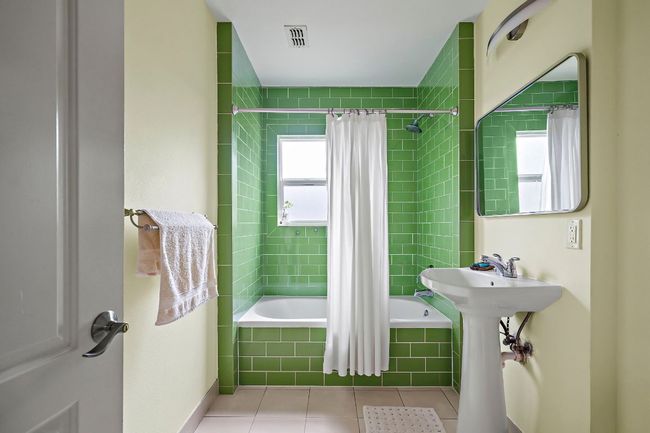 Bathroom featuring visible vents, tile patterned flooring, and tiled shower / bath combo | Image 21