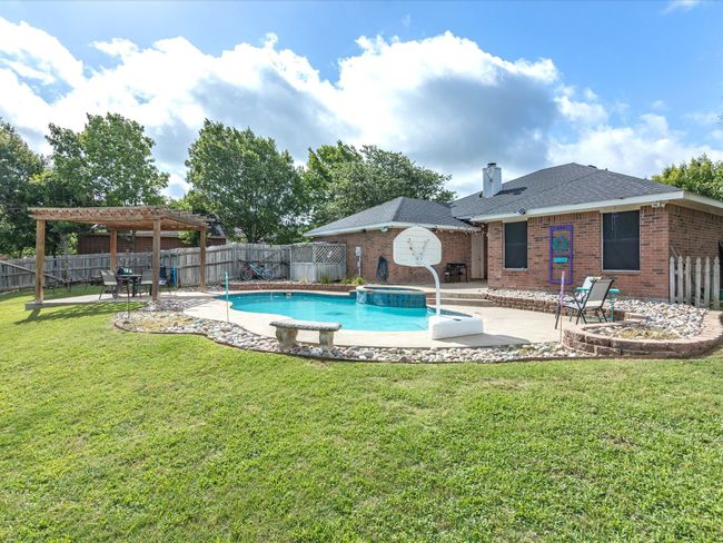 View of pool with a pergola, a patio area, a fenced backyard, and a pool with connected hot tub | Image 29