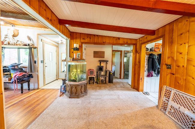 Entryway featuring wooden walls, wood finished floors, and a wooden ceiling with exposed beams | Image 9