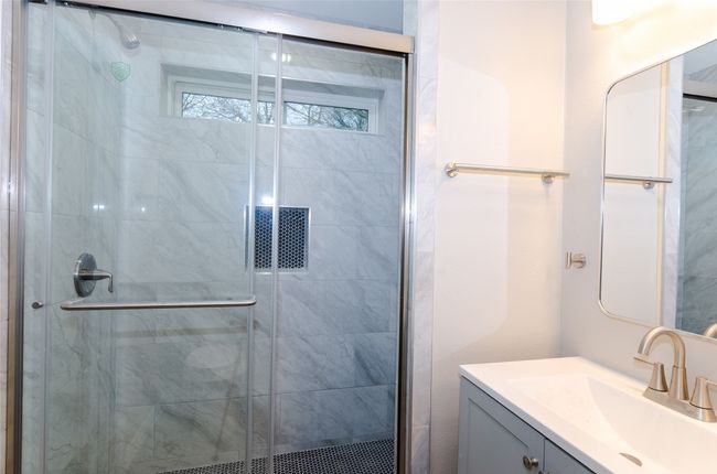 Bathroom featuring a shower stall and vanity | Image 10