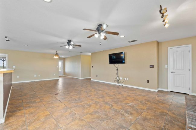 Unfurnished living room with a ceiling fan and recessed lighting | Image 9
