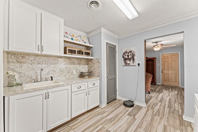 Utility sink and extra cabinetry make laundry a breeze! | Image 29