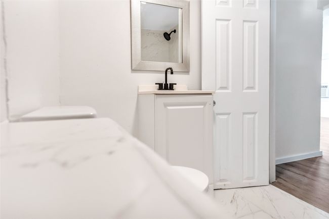 Full bath featuring vanity and marble finish flooring | Image 37