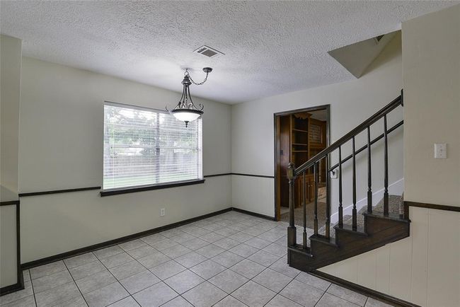 Breakfast nook leads to the stairs or the living room. | Image 12