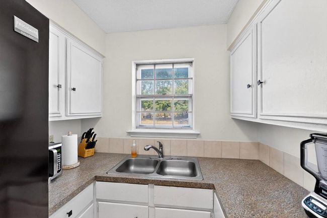 Kitchen featuring refrigerator and white cabinetry | Image 8