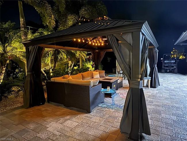 Patio at twilight featuring a gazebo and an outdoor living space with a fire pit | Image 17
