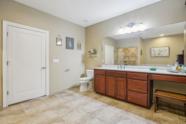Bathroom featuring vanity, a shower, and toilet | Image 27
