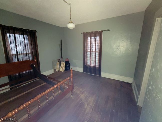 Bedroom featuring dark hardwood / wood-style floors | Image 8