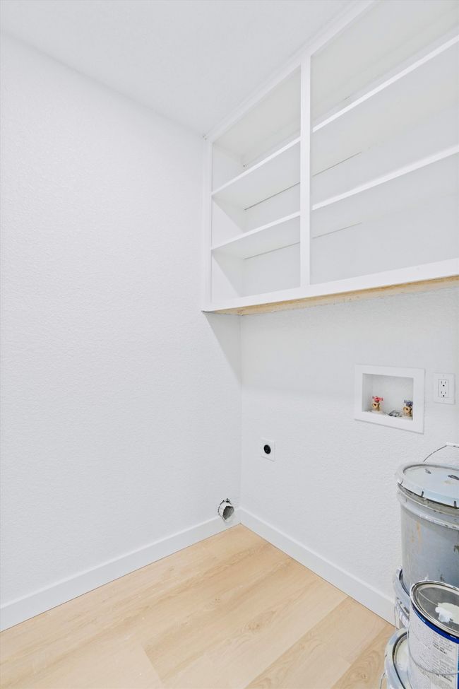 Laundry room with hookup for a washing machine, wood finished floors, and hookup for an electric dryer | Image 24