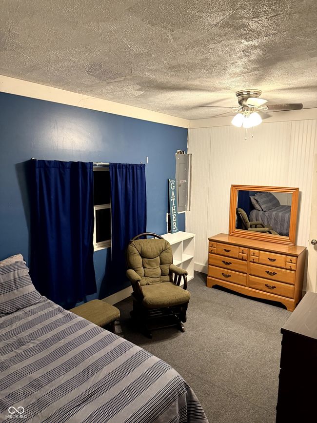 carpeted bedroom featuring a textured ceiling and ceiling fan | Image 17