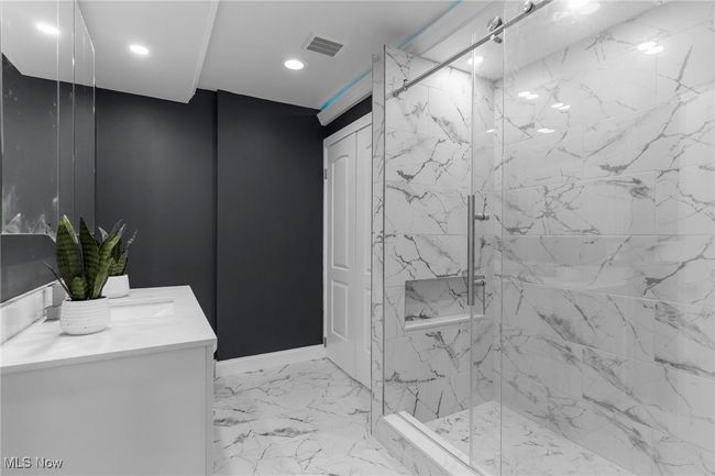 Full bath with vanity, a marble finish shower, marble finish floors, and recessed lighting | Image 22