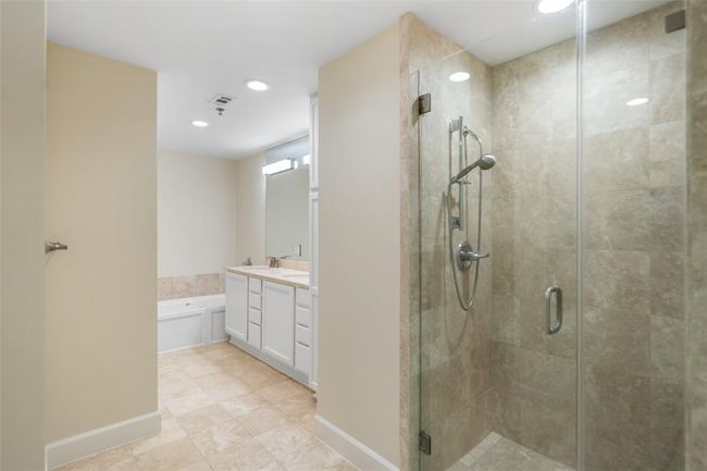Luxurious ensuite with a sleek glass shower. | Image 27