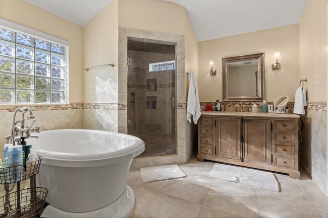 Bathroom featuring vanity, tile walls, LARGE shower and Deep Soaker Tub, tile patterned flooring. | Image 29