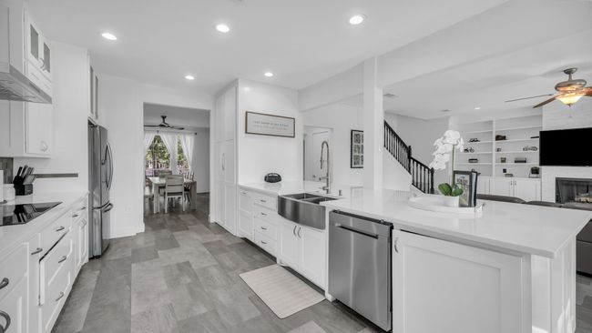 Kitchen featuring ceiling fan, stainless steel appliances, a peninsula, open floor plan, and recessed lighting | Image 11