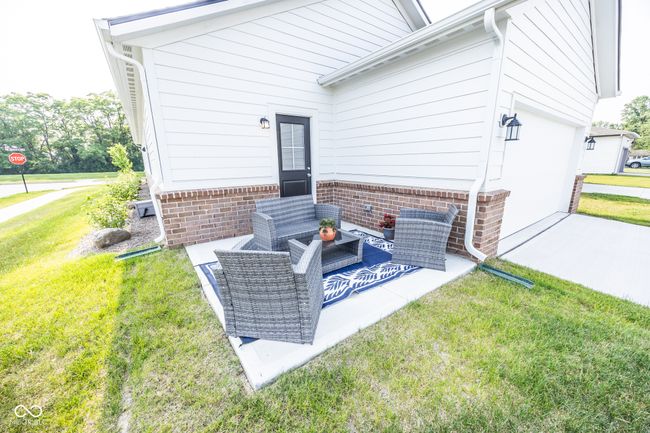 view of patio featuring concrete driveway and an attached garage | Image 18