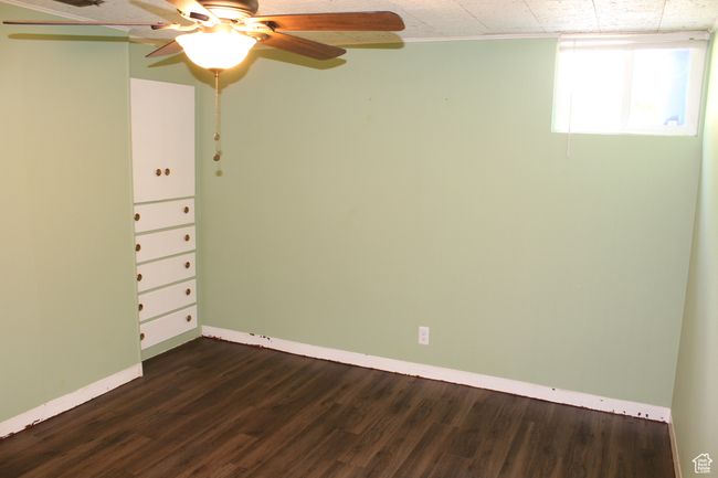 Spare room featuring dark wood-type flooring and ceiling fan | Image 21