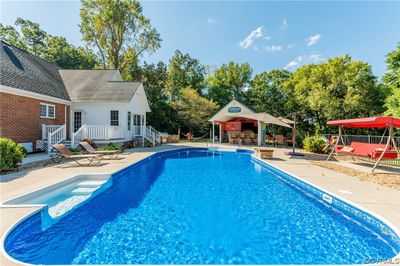 View of swimming pool with a patio and a playground | Image 2