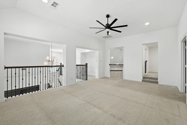 Empty room with ceiling fan, carpet, recessed lighting, and a chandelier | Image 22