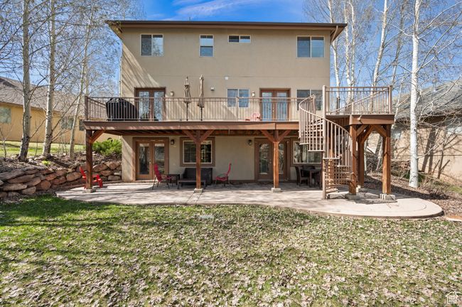Rear view of property with a patio area, a deck, french doors, and stucco siding | Image 32