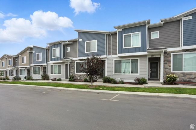 Townhome property with board and batten siding, a residential view, and stone siding | Image 43