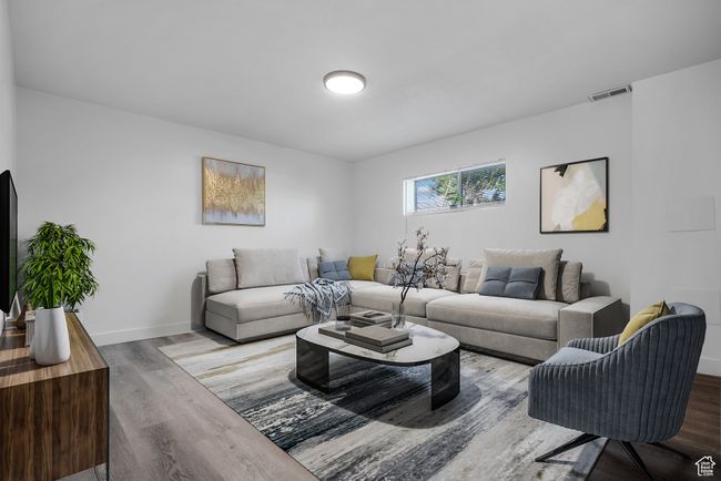 Living area featuring wood finished floors and baseboards | Image 5