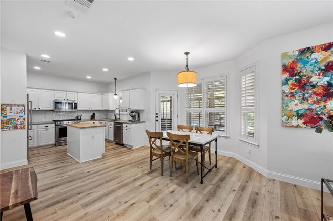 A bright and open kitchen with gas cooking, tons of storage, and a center island for easy meal prep. | Image 5