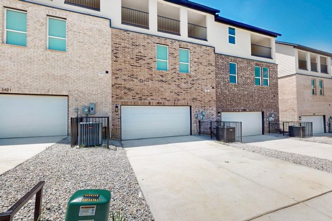 View of building exterior featuring driveway and a garage | Image 40
