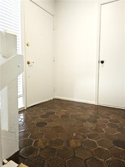 Open concept great room extended area for office space below the ceiling fan. | Image 3