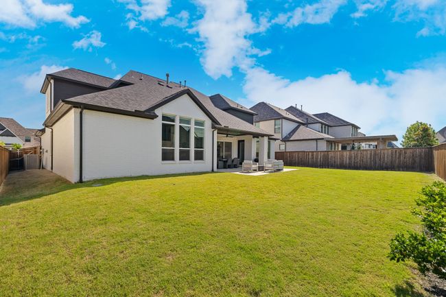 Rear view of property with ceiling fan, a patio area, roof with shingles, brick siding, and outdoor lounge area | Image 38