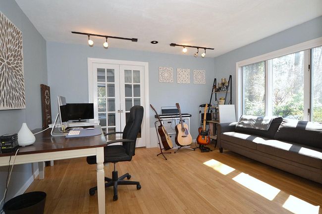 Office area with light wood finished floors, track lighting, and french doors | Image 13