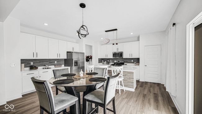 dining space featuring recessed lighting and wood finished floors | Image 14